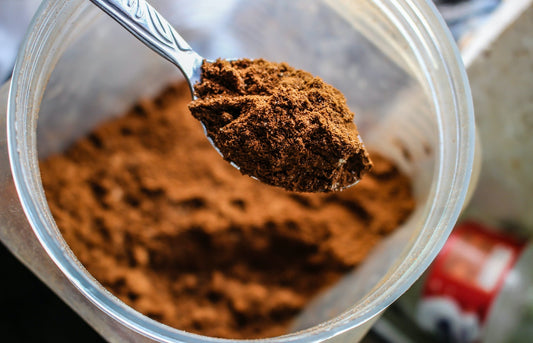 Cacao powder in glass jar. Blog. Health benefits of Cacao.